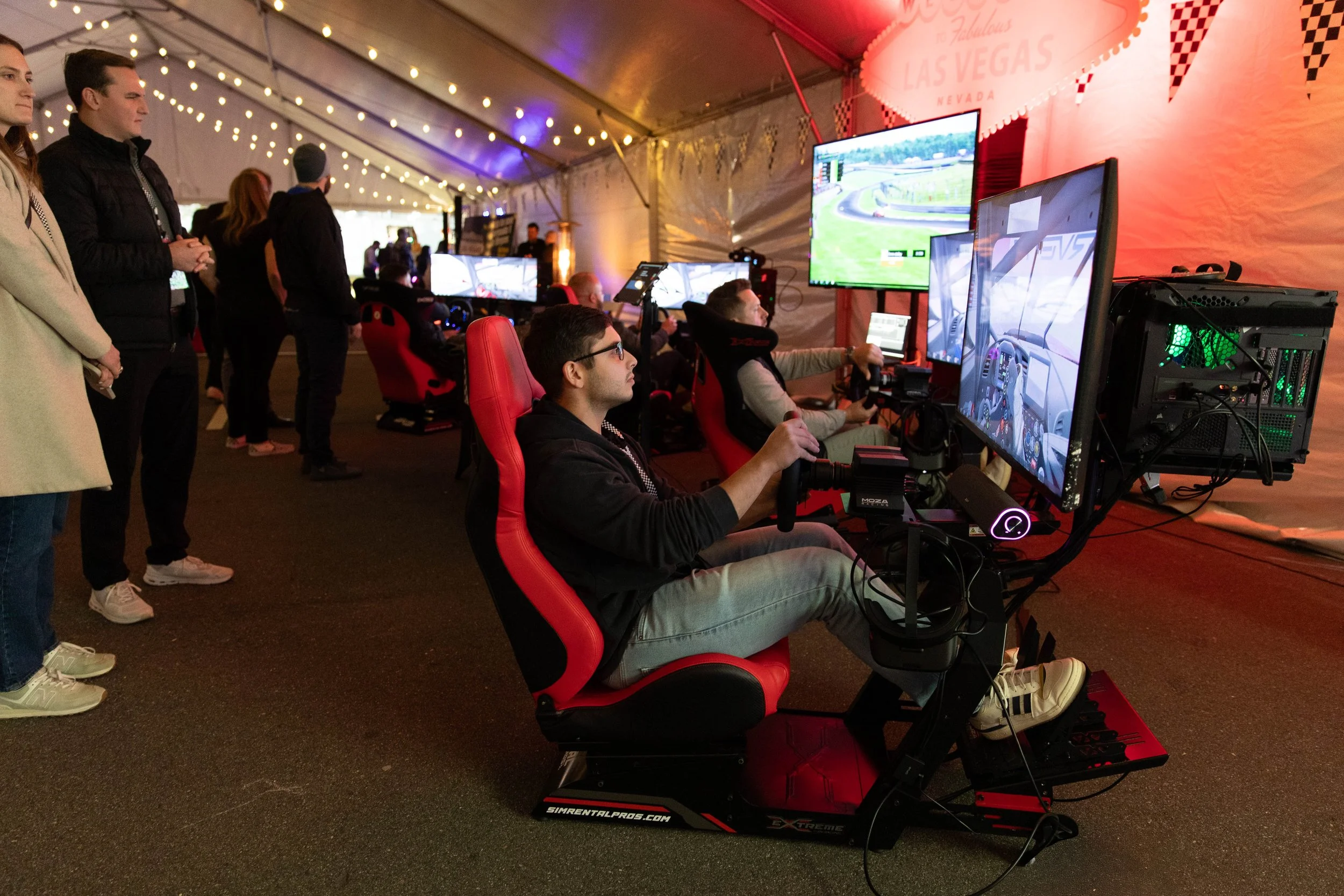 Guest experiencing a professional racing simulator at a live event